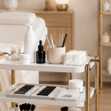 Professional lash salon setup including treatment bed, lash supplies, and clean beauty salon space