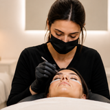 Professional eyelash extension application by a certified lash technician in a luxury beauty salon.