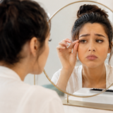 Woman checking her lash extensions in the mirror