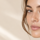 Woman wearing soft, natural-looking eyelash extensions inspired by the ghost-lash trend.