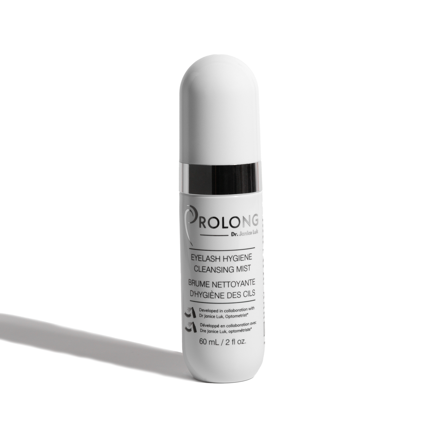 A white cylindrical cosmetic bottle w labeled 'PROLONG DR. JANICE LUK EYELASH HYGIENE CLEANSING MIST' on a clean white background with a soft shadow.