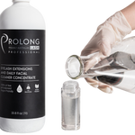 Prolong Lash Professional eyelash extensions and daily facial cleaner concentrate with a gloved hand holding a smaller bottle.